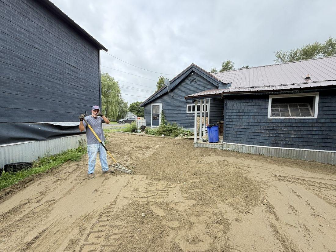 Before: bare graded ground beside the barns